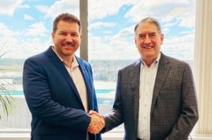 Two men shaking hands following the acquisition of the assets of the William Fall Group